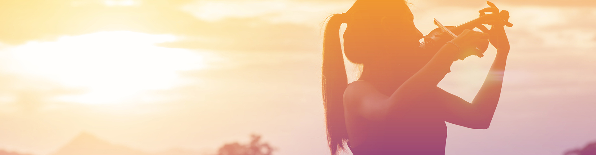 Silhouette women play violin sunset background